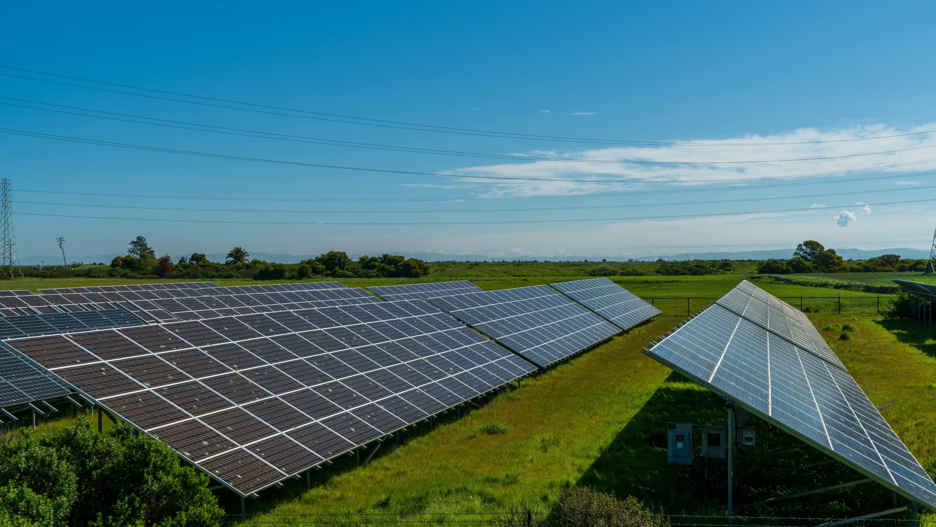 Solar panels in a lush rural field, generating renewable energy in San Rafael, CA.